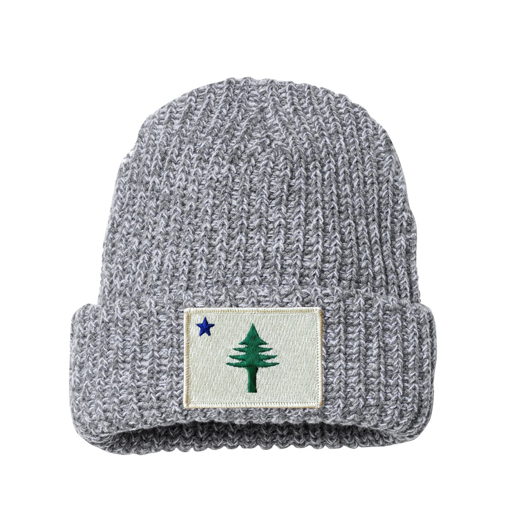Gray knit beanie with a patch featuring a star and a tree from the 1901 Maine state flag on a white background