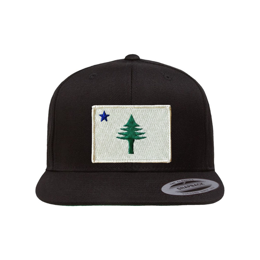 Black cap with patch of the 1901 Maine state flag on a white background