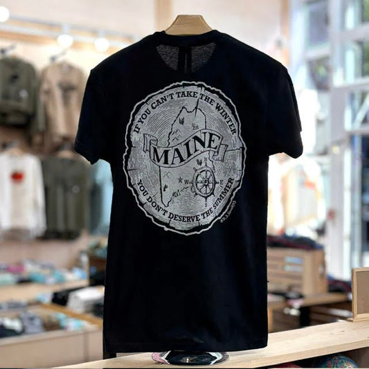Black t-shirt with 'Maine' graphic design on a mannequin in a store setting.